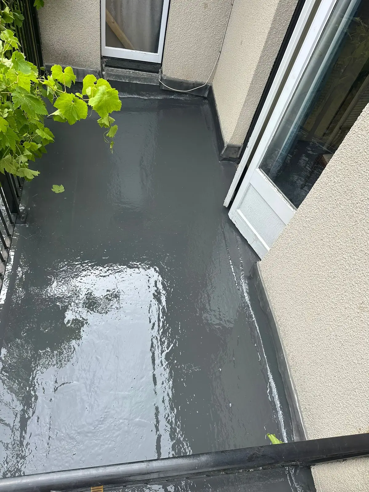 Freshly coated GRP balcony beside patio doors