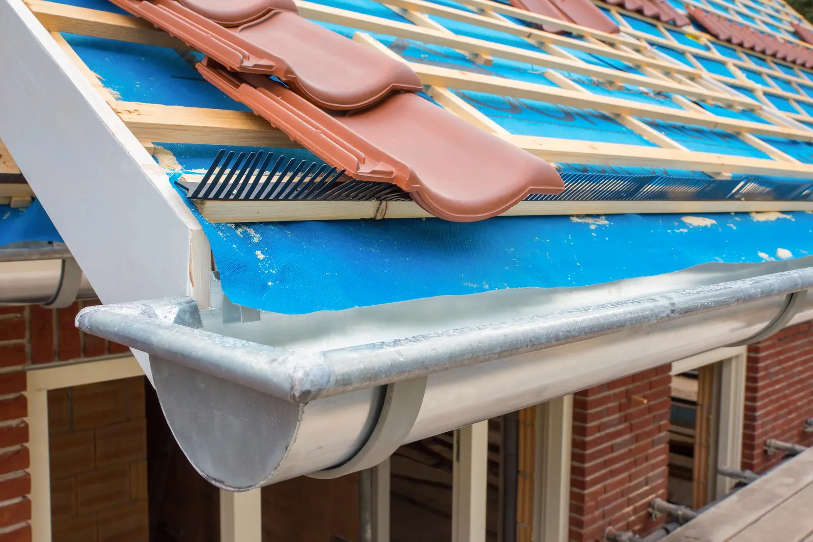 New gutter at the eaves below new roof tiles