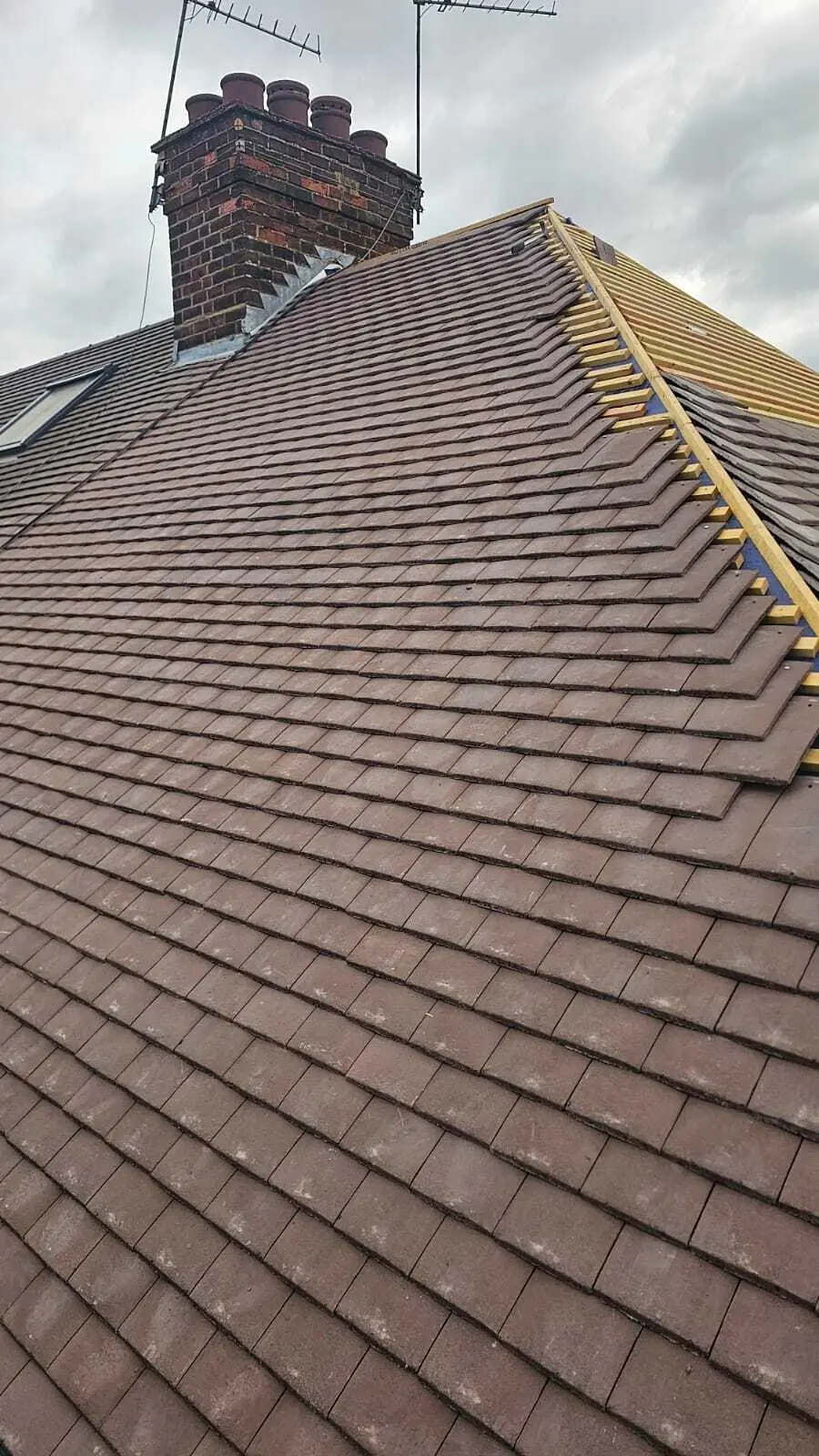 New plain tiles at the verge of a re-roof