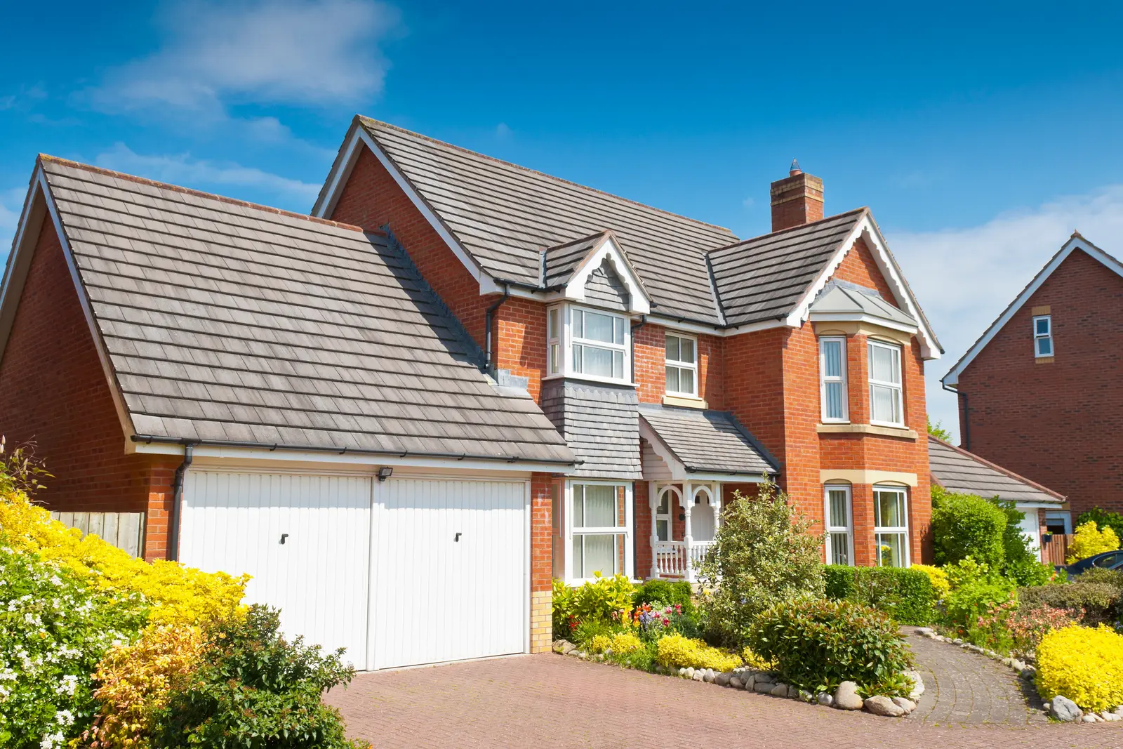 Brick house with a grey concrete tiled roof