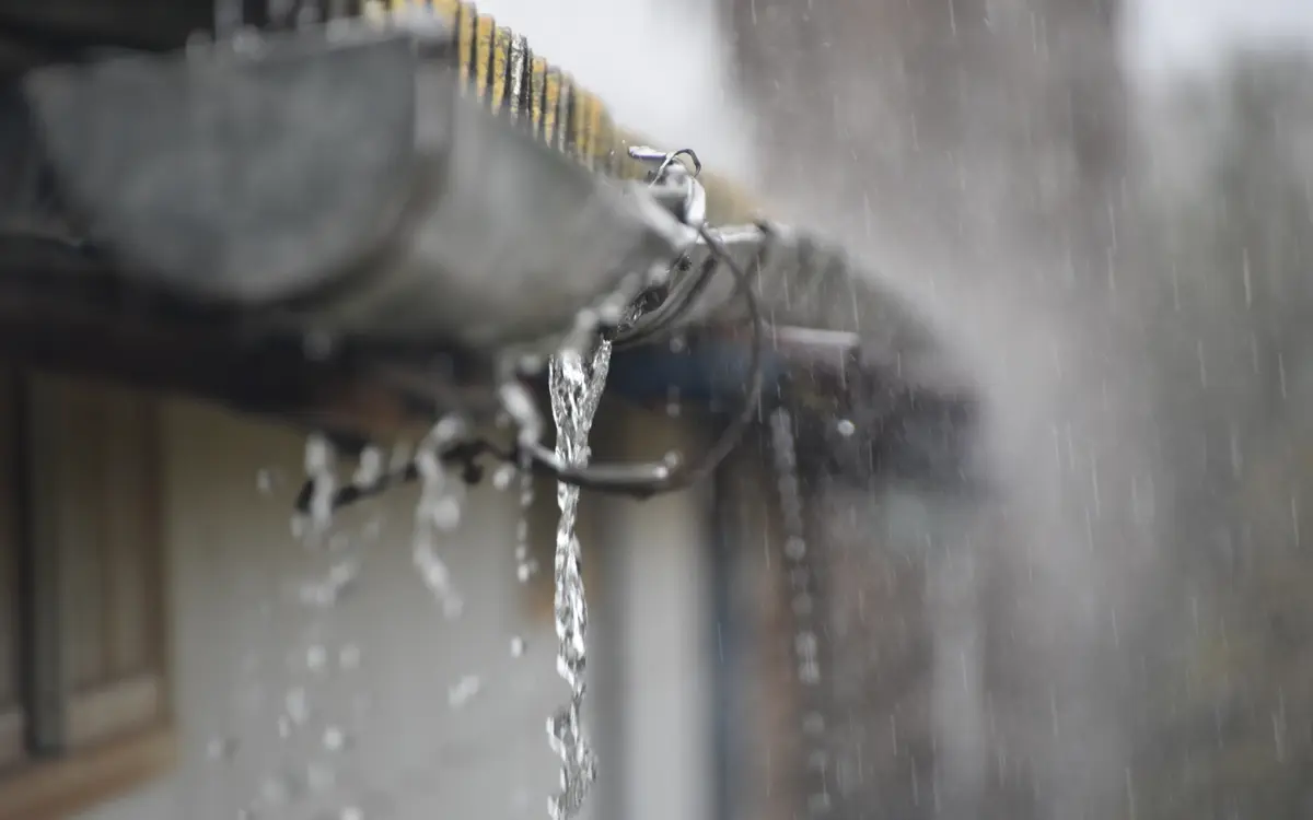 Rainwater overflowing from a blocked gutter