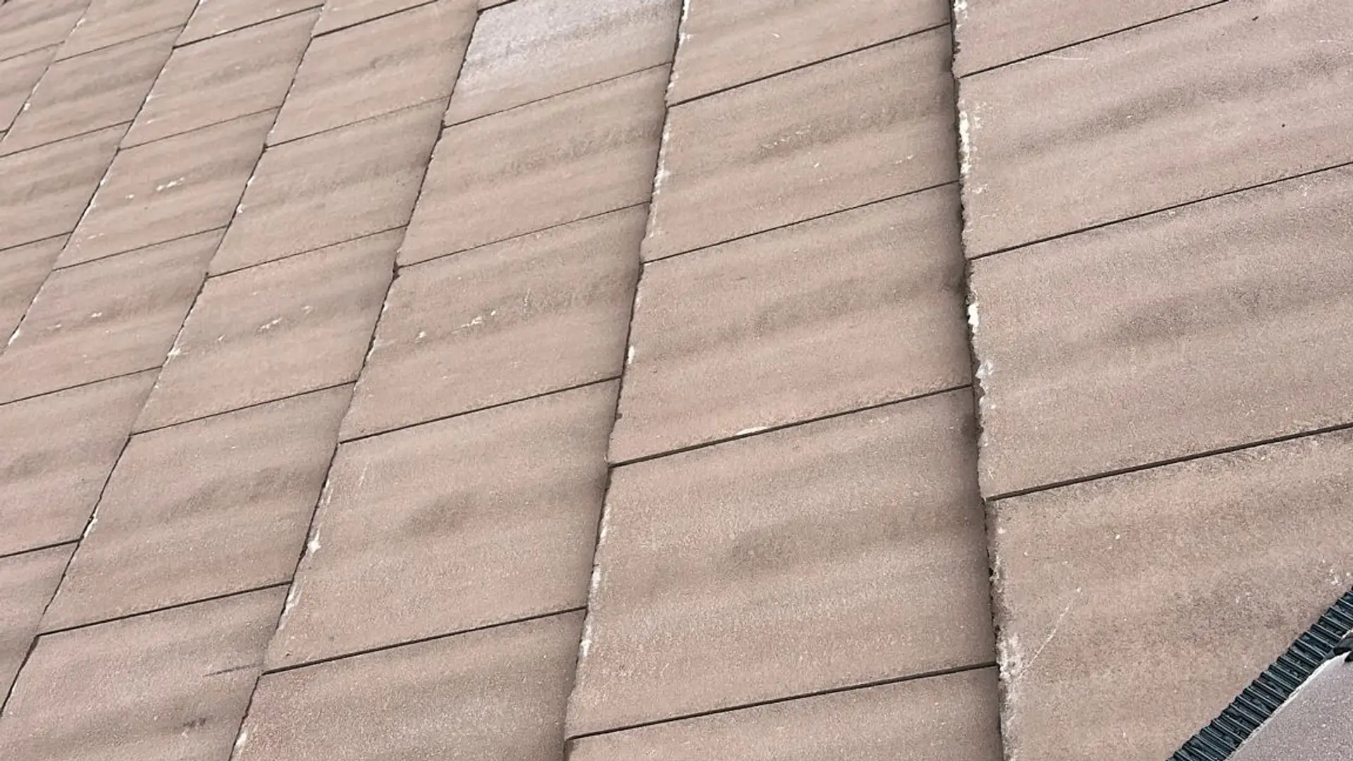 Close view of new brown concrete plain tiles laid on a re-roof