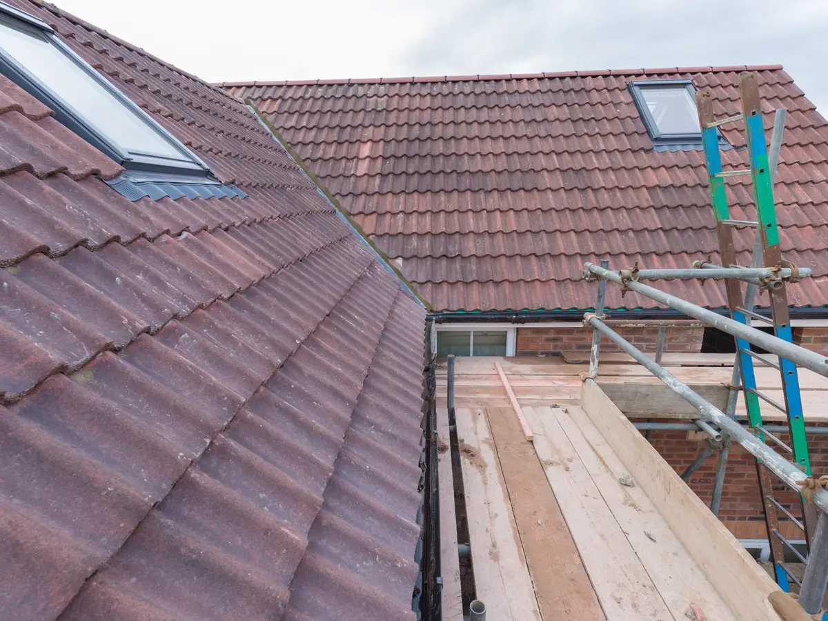 Scaffold platform alongside a tiled roof ready for repair work