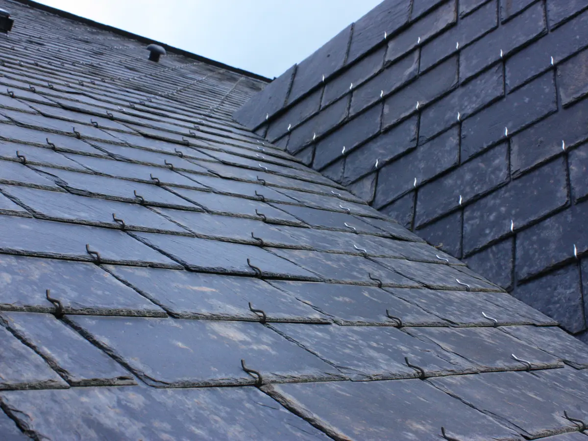 Natural slate roof slopes meeting at a valley